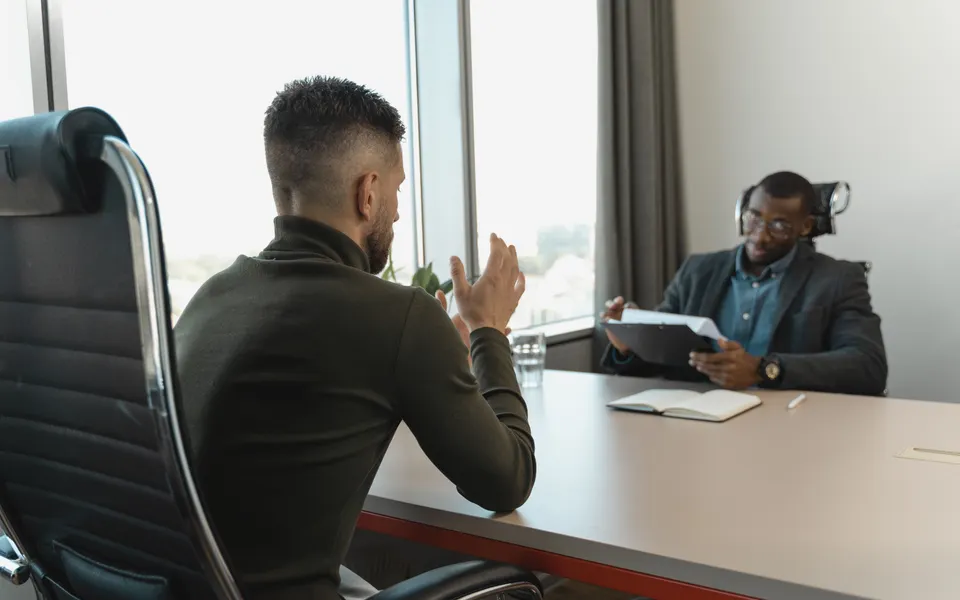Two people in conversation at a desk