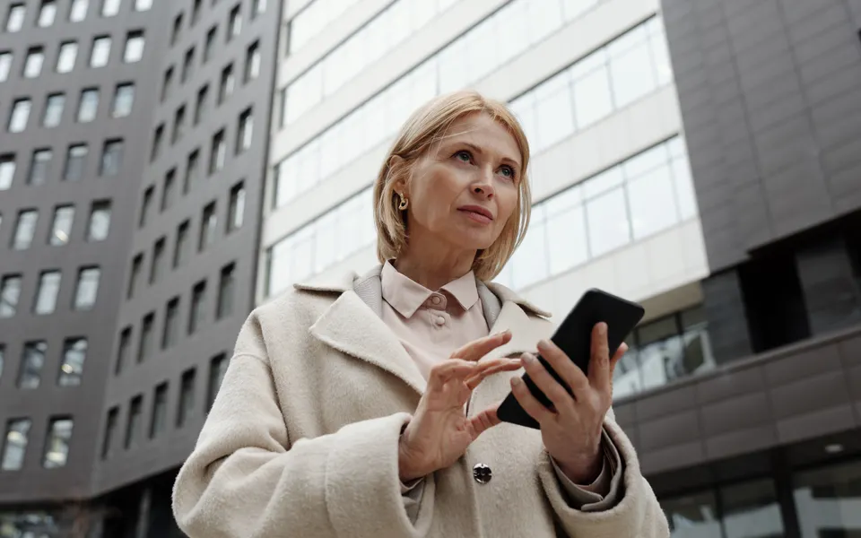 A professional using her smartphone outside the office